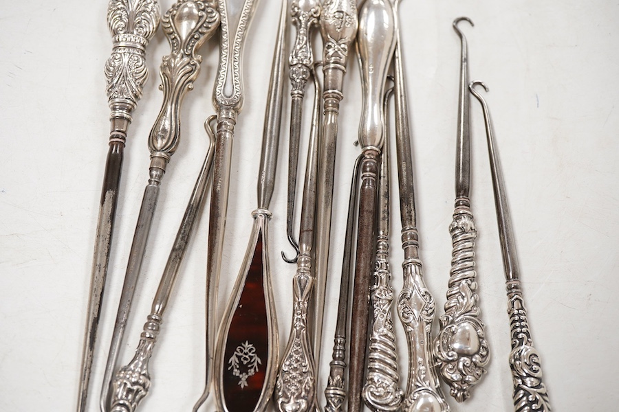 A collection of fourteen assorted late 19th/early 20th century silver handled button hooks, including tortoiseshell pique, longest 24.4cm.